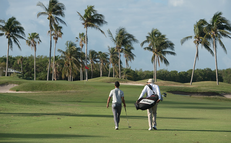Golfers walking on golf course